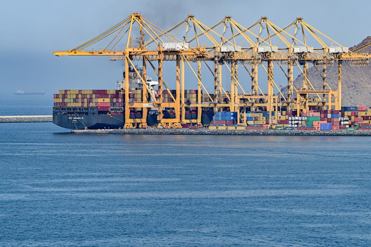 The Cyprus-flagged container vessel MSC Aquarius VII is docked along a pier at the Khor Fakkan Container Terminal, the only natural deep-sea port in the region and one of the major container ports in Sharjah Emirate, along the Gulf of Oman, June 19, 2026. (AFP Photo)