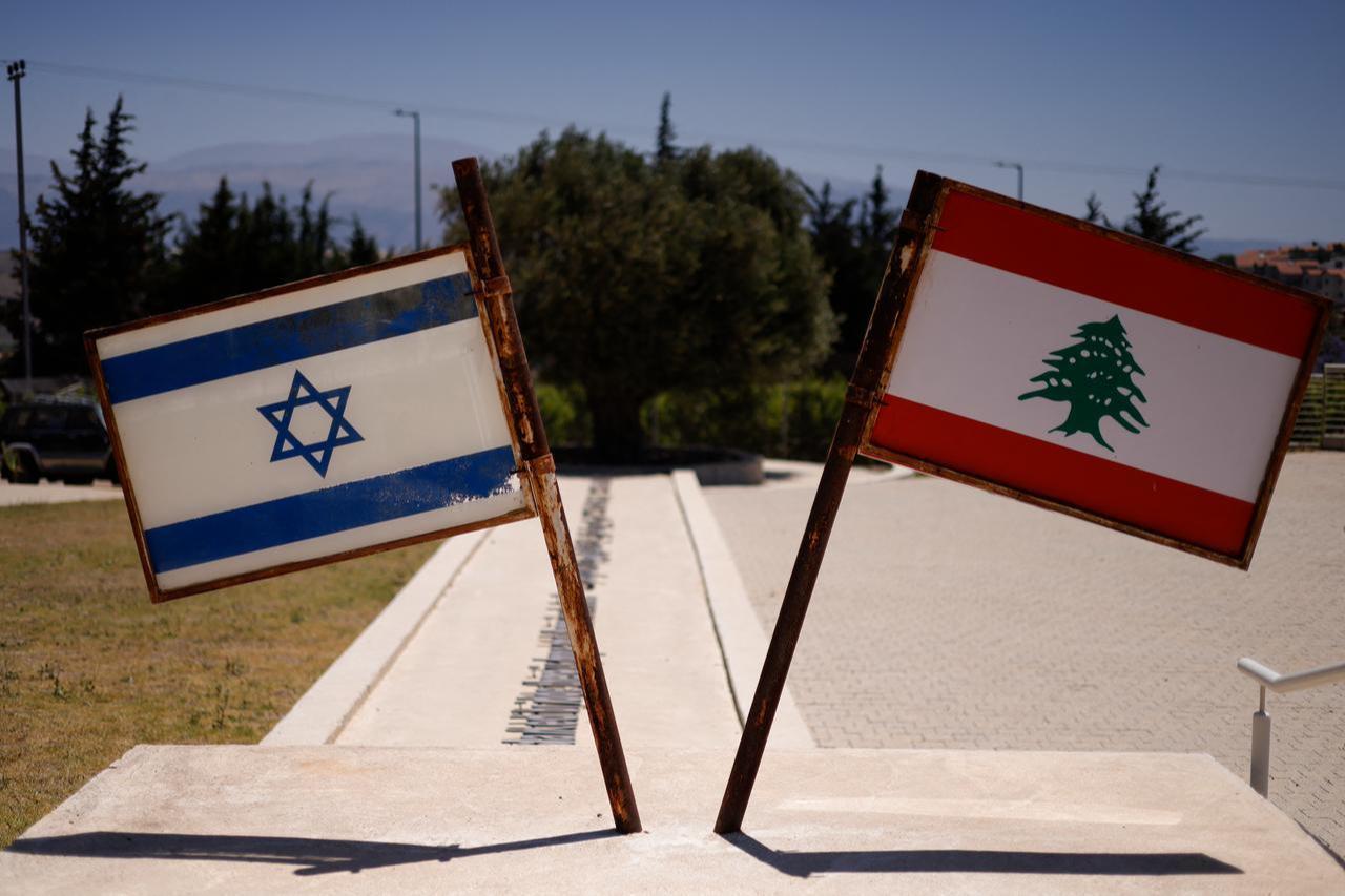 Israeli and Lebanese flags are pictured at a monument called the "Good Fence" in the northern town of Metula bordering Lebanon, June 18, 2026. (AFP Photo)