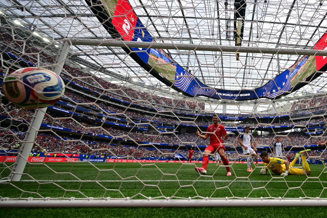 Bosnia-Herzegovina's goalkeeper #01 Nikola Vasilj concedes Switzerland's third goal scored by midfielder #09 Johan Manzambi (unseen) during the 2026 World Cup Group B football match between Switzerland and Bosnia and Herzegovina at Los Angeles Stadium in Inglewood on June 18, 2026. (AFP Photo)