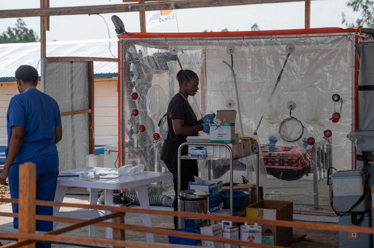 Doctors prepare medication for patients suffering from or suspected of having Ebola virus disease and compile medical monitoring lists displayed on a board inside a tent used for coordination and report writing at the Ebola treatment centre of Rwampara General Reference Hospital in Rwampara, Ituri Province, Democratic Republic of Congo, June 12, 2026. (AFP Photo)