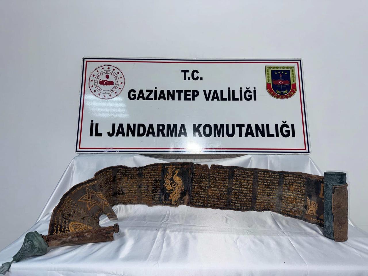 A python-skin book bearing gold Hebrew inscriptions, seized during an anti-smuggling operation in Gaziantep, Türkiye, April 25, 2026. (IHA Photo)