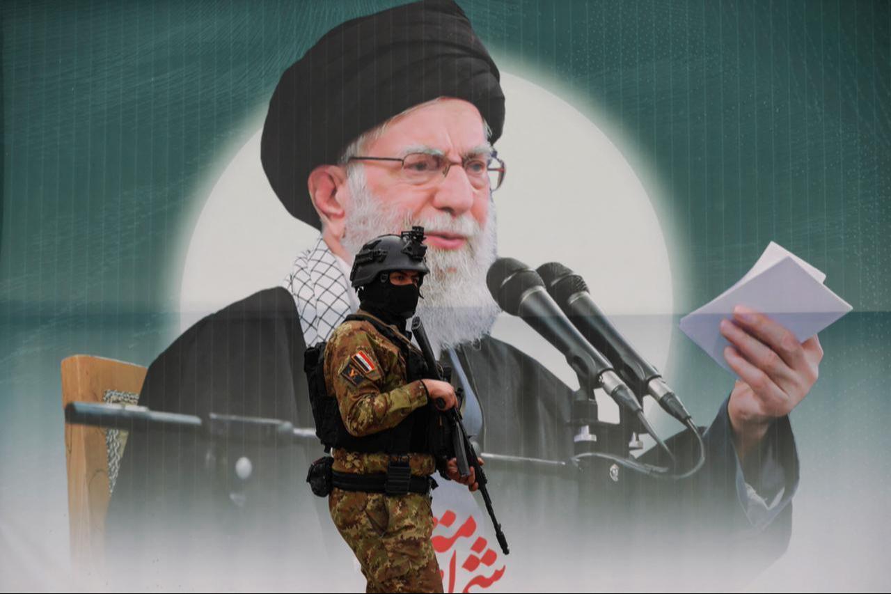 A member of Iraq's Hashed al-Shaabi Forces stands in front of a banner depicting Iran’s slain supreme leader Ali Khamenei in Baghdad's Tahrir Square, Iraq, March 12, 2026. (AFP Photo)
