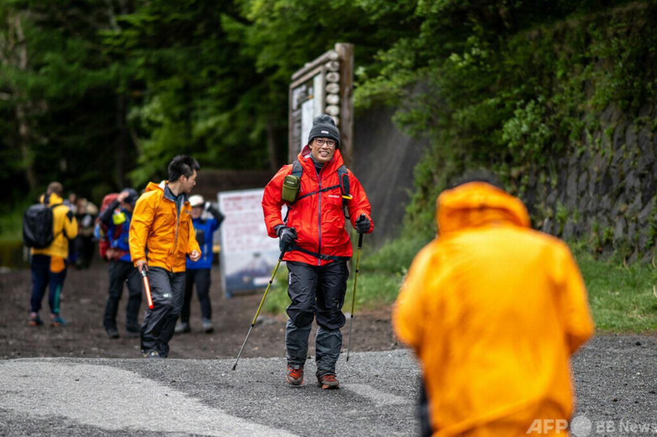 Hikers walk out from the newly-built trail gate at Fuji Subaru Line 5th station, July 1, 2024. (AFP Photo)