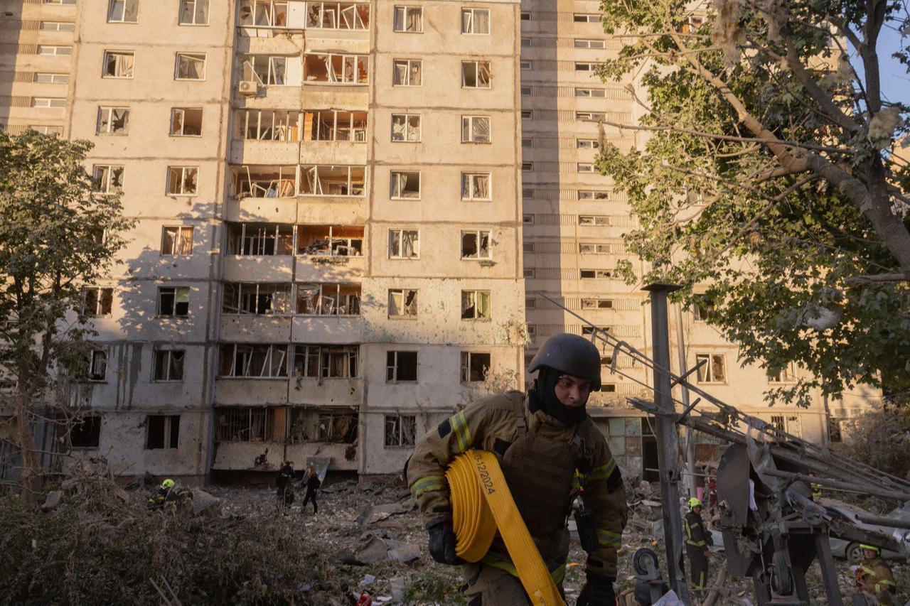 A firefighter works outside a multi-story residential building damaged following massive Russian missile and drone strikes on Kyiv on June 2, 2026. (AFP Photo)