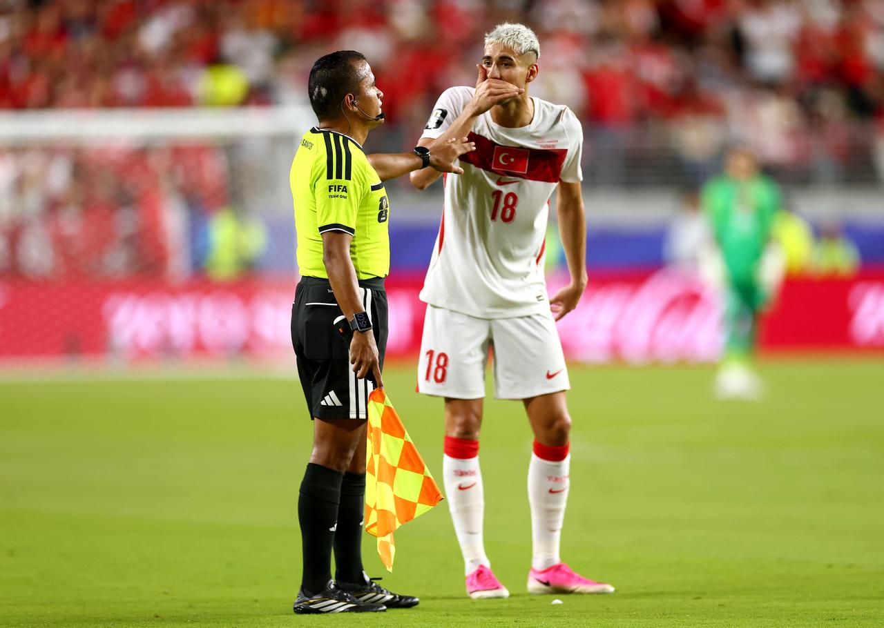 Mert Muldur #18 of Turkiye flags Miguel Almiron #10 (not pictured) of Paraguay for covering his mouth during the FIFA World Cup 2026 Group D match between Türkiye and Paraguay at San Francisco Bay Area Stadium in Santa Clara, California, June 19, 2026. (AFP Photo)
