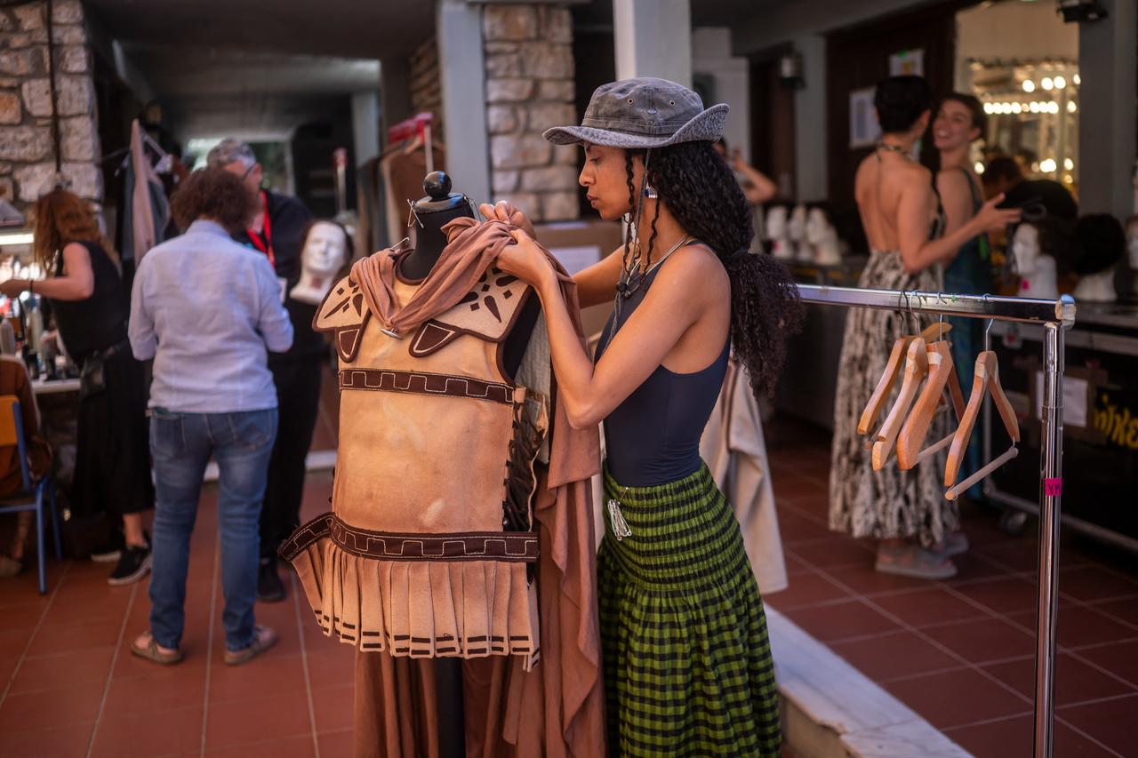 Woman prepares a costume for the opera 'Medea' at the Ancient Greek theatre of former city Epidaurus, in Nea Epidavros on June 18, 2026. (AFP Photo)