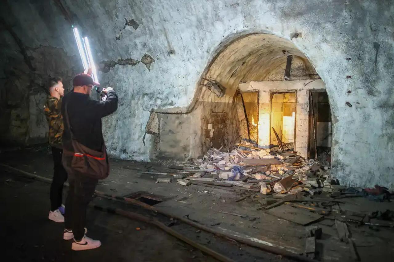 Visitor Angelo Virag (R) takes a picture next to Mario Garbin (L) inside a tunnel at Zeljava underground army airbase in the heart of the Pljesevica mountain, on Croatia’s border with Bosnia, on October 4, 2023. (AFP Photo)