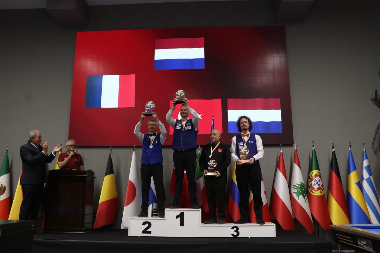 Türkiye’s Serdar Gümüş (second right) poses on the podium after winning bronze at the Artistic Billiards World Championship in Ankara, Türkiye, June 20, 2026. (AA Photo)