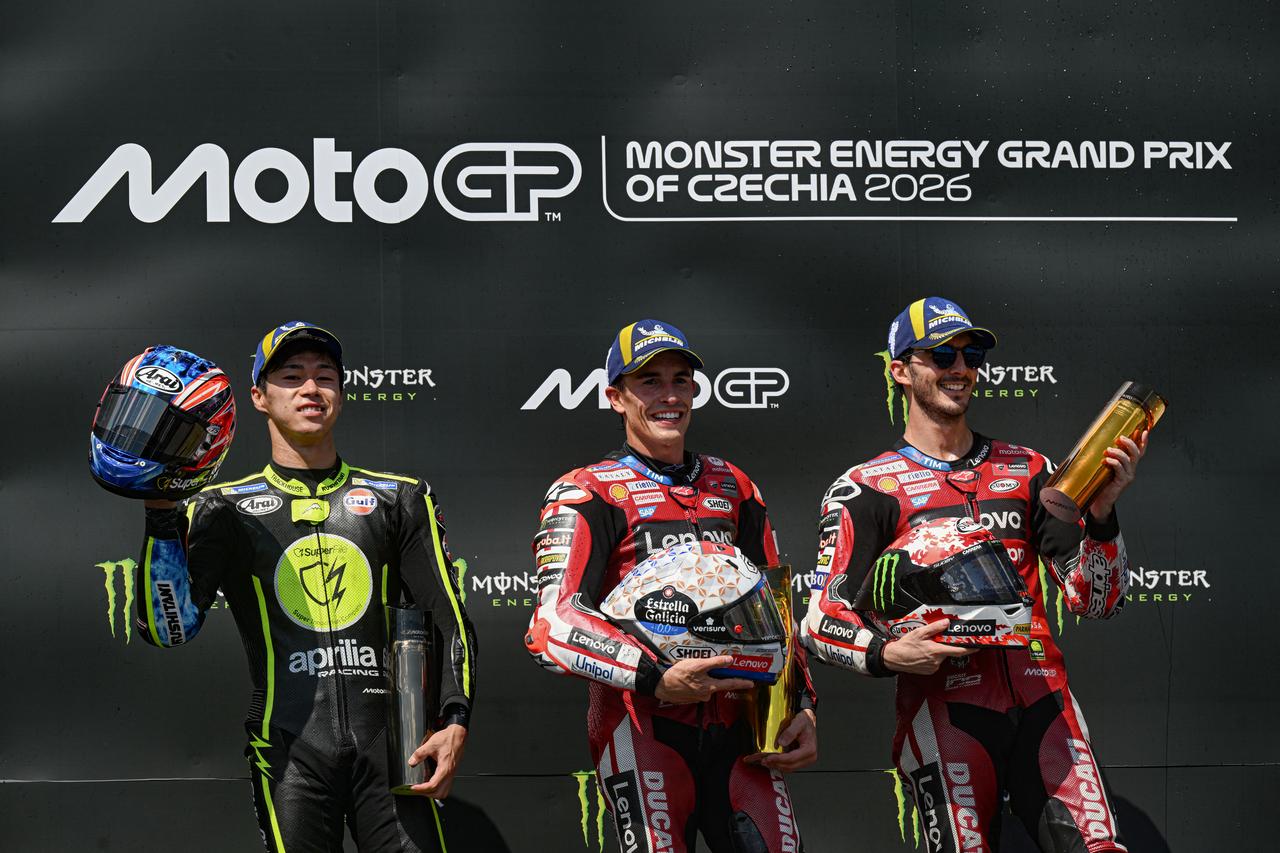 (L-R) Second placed Team Trackhouse Racing MotoGP's Ai Ogura, winner Team Ducati Lenovo Team's Marc Marquez and third placed Team Ducati Lenovo Team's Francesco Bagnaia on the podium. (AFP Photo)