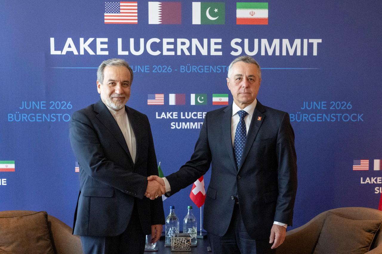 Iran's Minister of Foreign Affairs Seyyed Abbas Araghchi (L) and Swiss Federal Council, Ignazio Cassis shake hands as they take part in bilateral discussions at the Burgenstock resort in Obbuergen, near Lucerne, June 21, 2026. (AFP Photo)