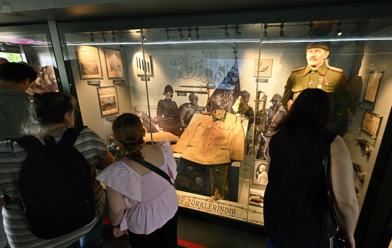 Visitors examine exhibition panels and wartime materials inside the Canakkale Wars Mobile Museum in Brussels, Belgium. (AA Photo)