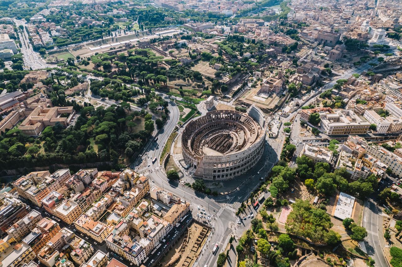 An aerial shot of the Colosseum and the Imperial Forums in Rome, Italy (Adobe Stock Photo)