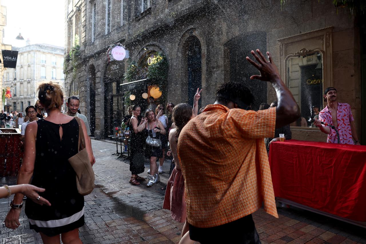 Partygoers dance in a street while taking part in the annual street music festival 'Fete de la Musique'  during a heatwave in Bordeaux,, France on June 21, 2026. (AFP Photo)