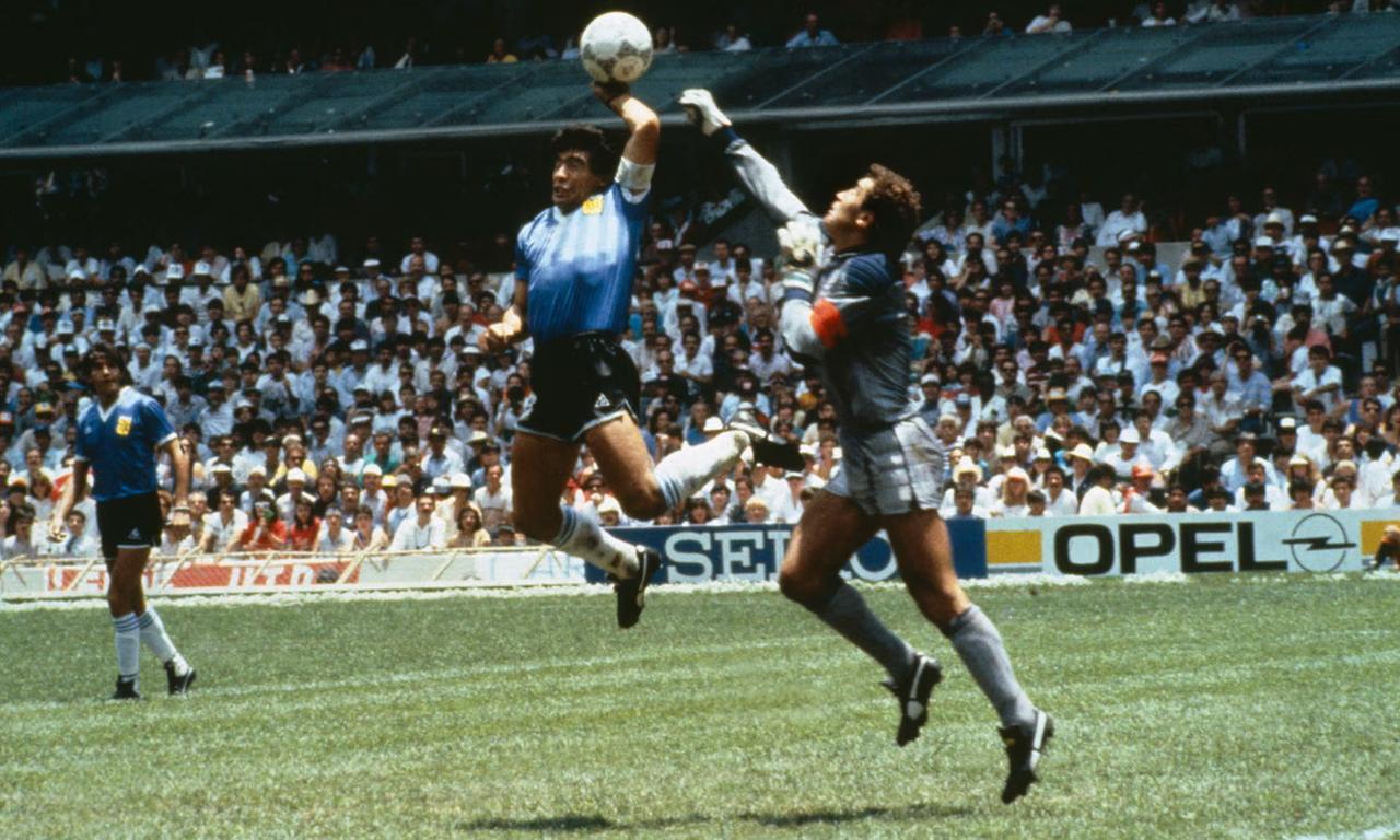Diego Maradona tickles the ball over the head of England’s Peter Shilton to give Argentina a 1-0 lead at the Azteca Stadium. (Photo by Bob Thomas)