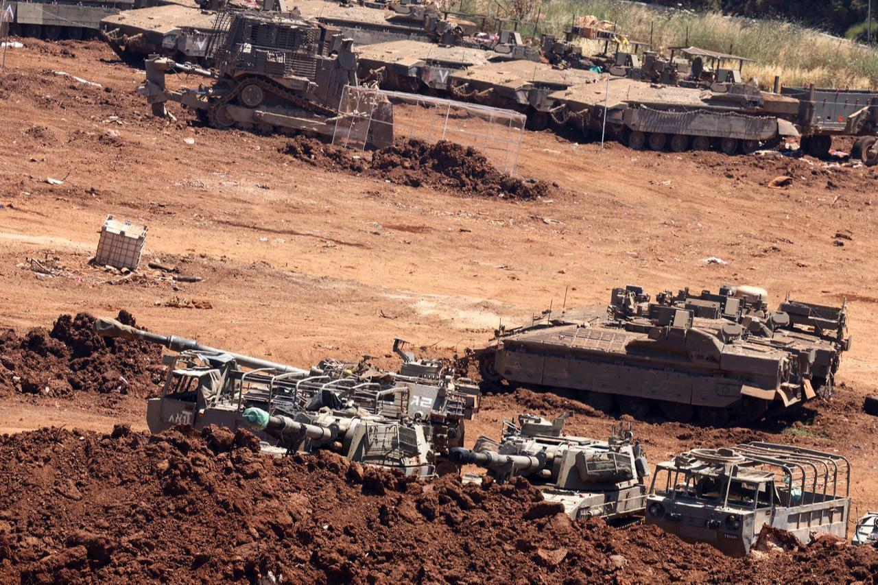 This picture taken from a position in the Upper Galilee in northern Israel, near the Israel-Lebanon border, shows Israeli army vehicles positioned along the border on June 17, 2026. (AFP Photo)