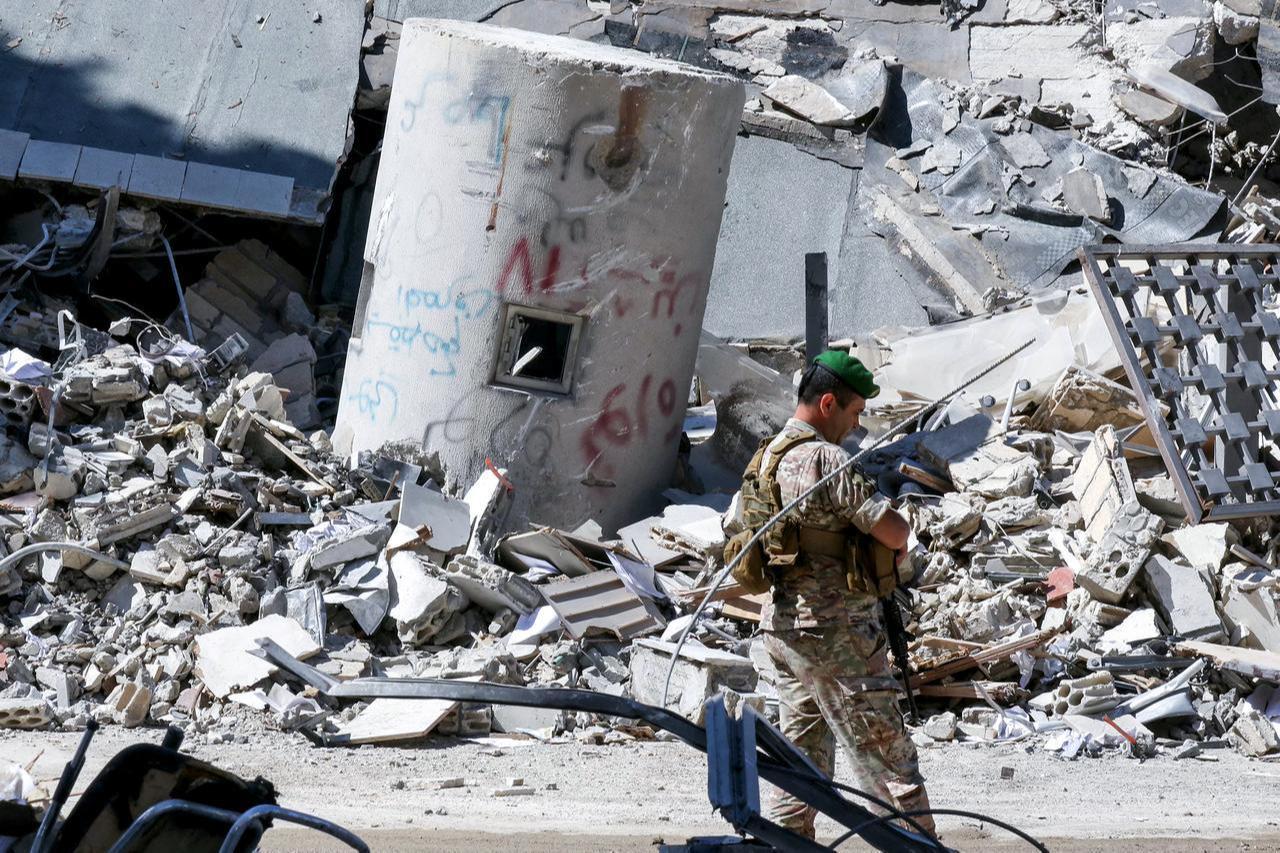 A Lebanese army soldier walks past the rubble of the local branch of the Banque du Liban, Lebanon’s Central Bank, following Israeli bombardment, in Nabatieh in southern Lebanon on June 21, 2026. (AFP Photo)