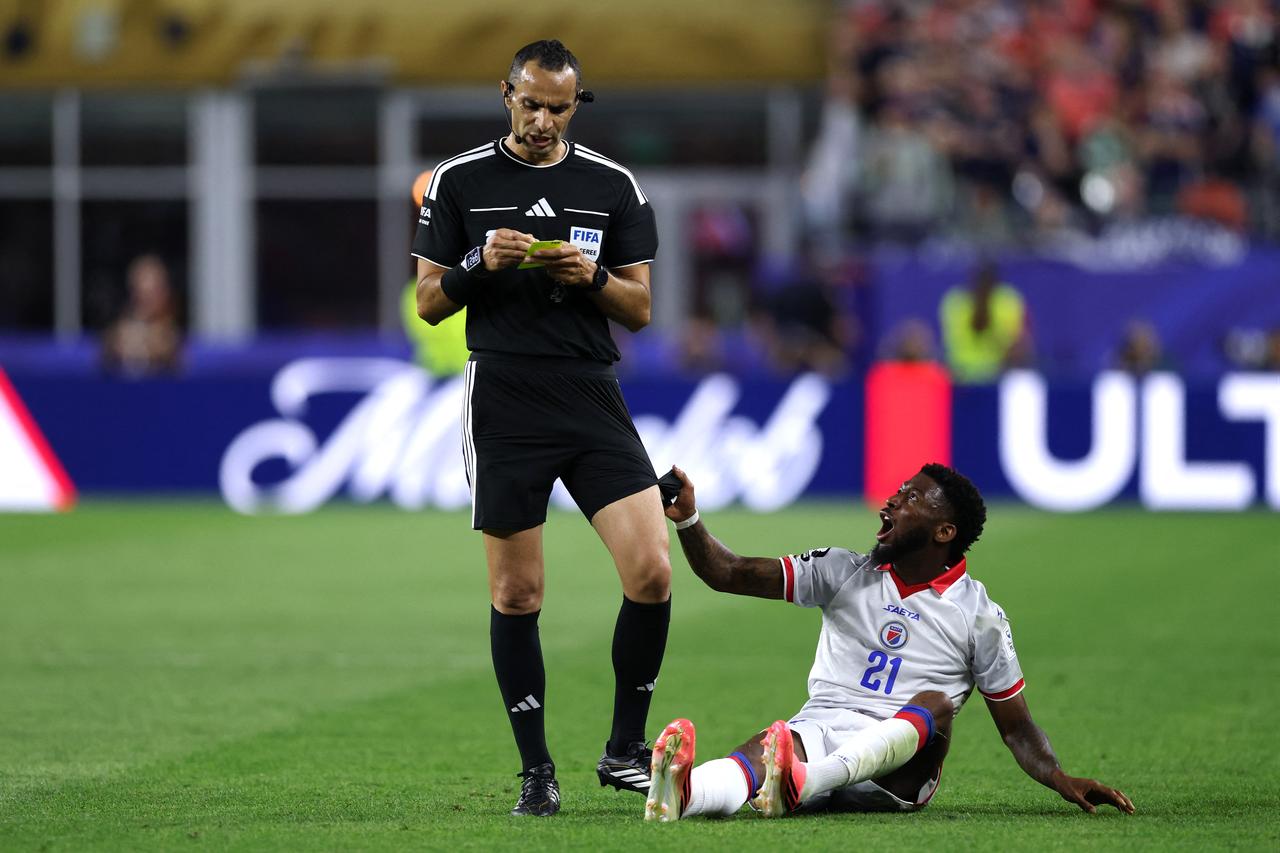 BOSTON, MASSACHUSETTS - JUNE 13: Josue Casimir #21 of Haiti pulls the shorts of referee, Mustapha Ghorbal during the FIFA World Cup 2026 Group C match between Haiti and Scotland at Boston Stadium in Foxborough, Massachusetts, US, June 13, 2026. (AFP Photo)