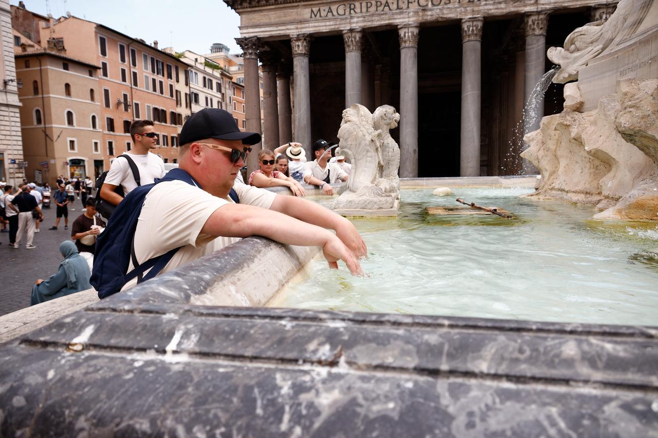 Tourists cool off at a fountain near the Pantheon as extreme heat affects Rome, Italy, June 22, 2026. (AA Photo)
