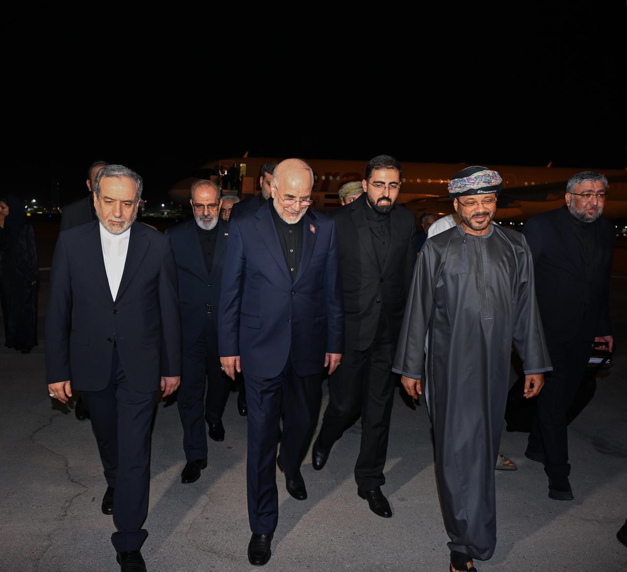 Iranian Parliament Speaker Mohammad Bagher Qalibaf (center) and Foreign Minister Abbas Araghchi (left) arrive in Muscat, Oman, on June 23, 2026. (Photo via X/@FMofOman)
