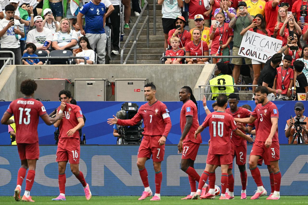 Portugal's forward #17 Rafael Leao (C) celebrates with teammates after scoring his team's fifth goal  during the 2026 World Cup Group K football match between Portugal and Uzbekistan at the Houston Stadium in Houston on June 23, 2026.  (AFP Photo)