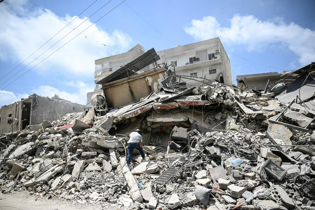 A man walks on the rubbles as he looks for items in a building hit in earlier Israeli military strikes on a neighbourhood in the southern Lebanese coastal city of Tyre, June 23, 2026. (AFP Photo)