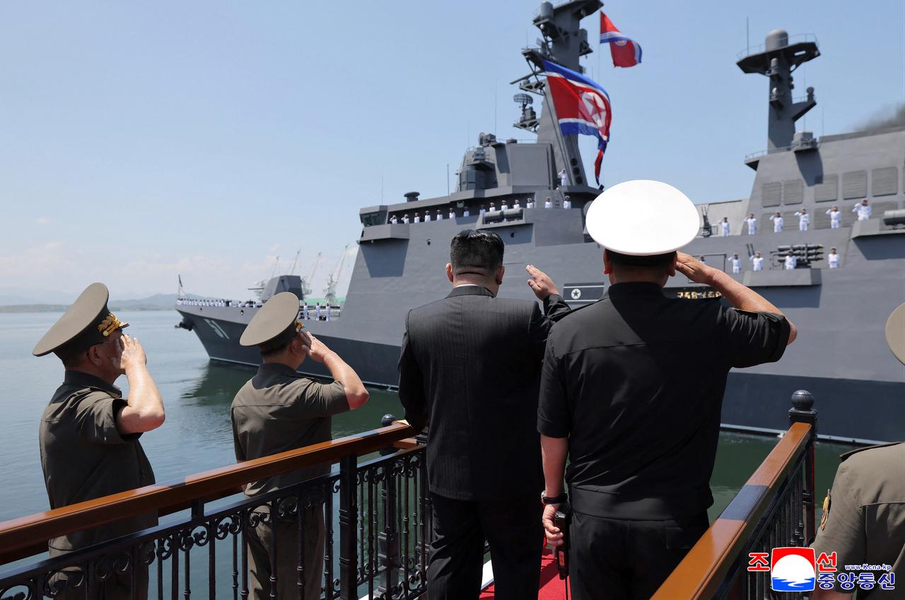 This picture taken on June 23, 2026 and released by North Korea's official Korean Central News Agency (KCNA) on June 24, 2026 shows North Korean leader Kim Jong Un (C) salutes the new-type multi-mission destroyer Choe Hyon following its commissioning ceremony at Nampo port in North Korea. (Photo via Korean Central News Agency (KCNA)/HO/AFP)