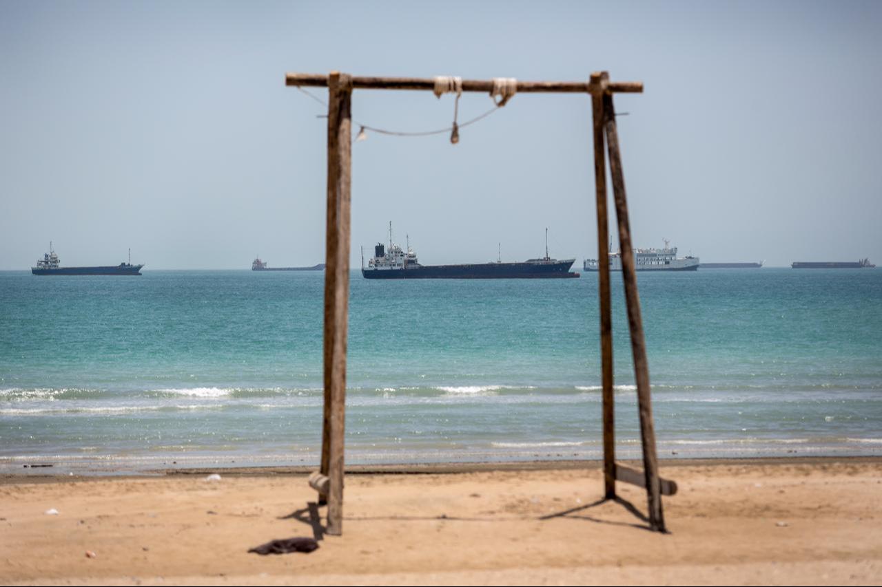 Iranian commercial ships are seen off the coast of Kong city in southern Iran on June 21, 2026, after the United States eased its blockade in the Strait of Hormuz. (AA Photo)