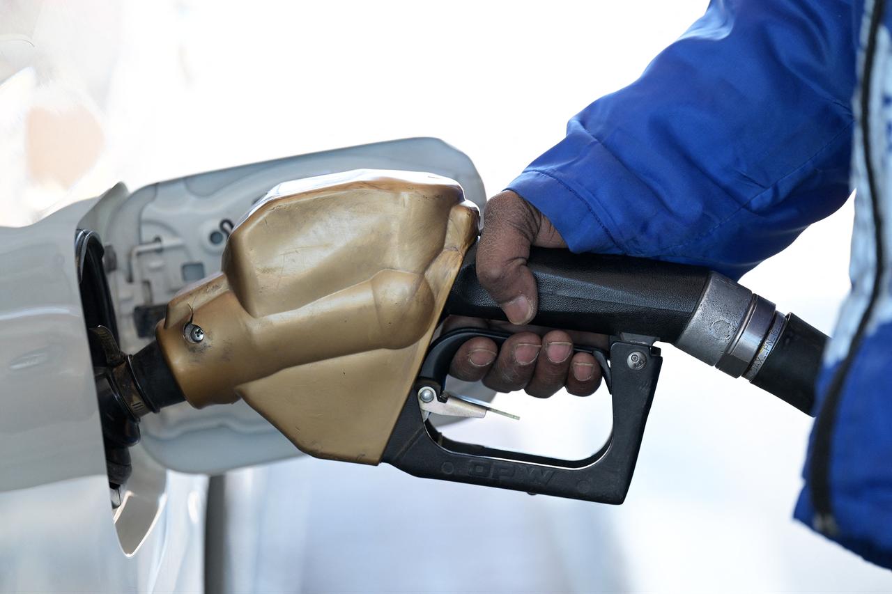 An employee refuels a car at a gas station in Kuwait City on March 10, 2026.  (AFP Photo)