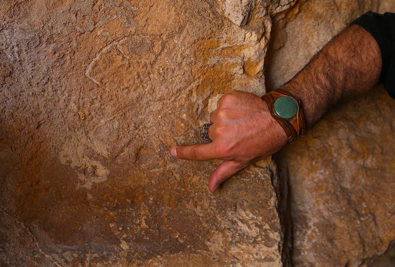 Professor Mehmet Sait Toprak points to markings inside the Mithras Temple at Zerzevan Castle, where an inscription showed the sanctuary was sealed around 1,700 years ago. (AA Photo)