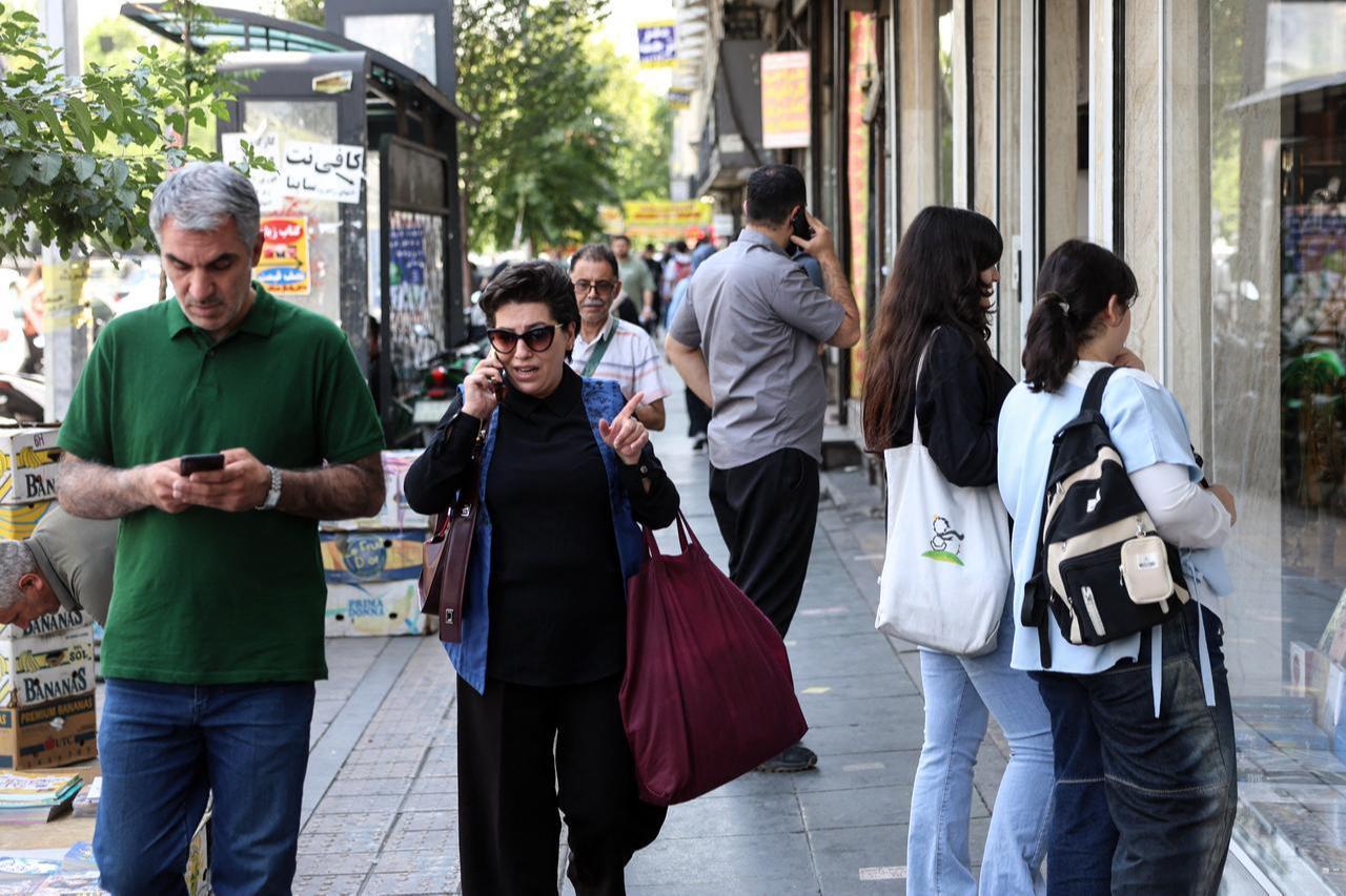 Iranians walk through a street in Tehran on June 18, 2026. (AFP Photo)
