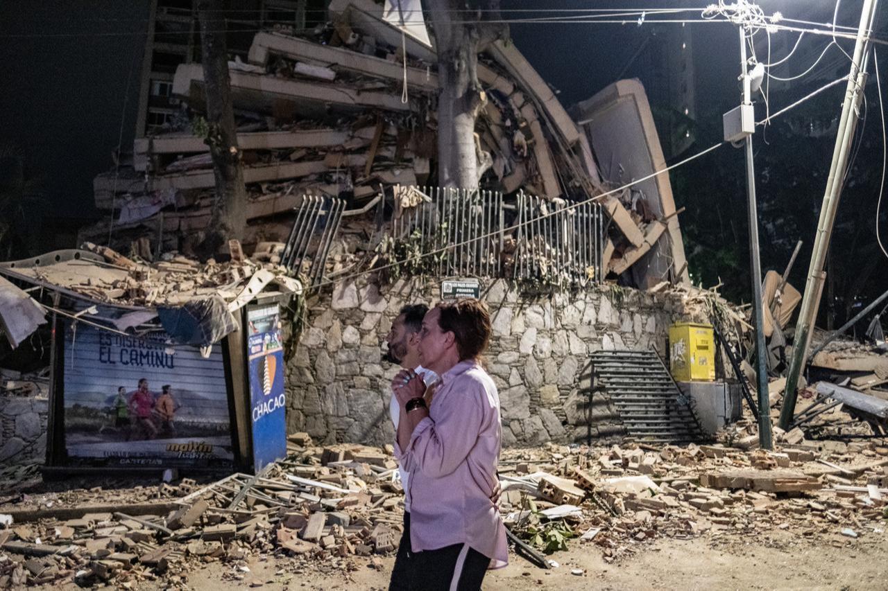 Residents stand near the rubble of a collapsed building following a powerful earthquake in Caracas, Venezuela, on June 24, 2026. (AA Photo)