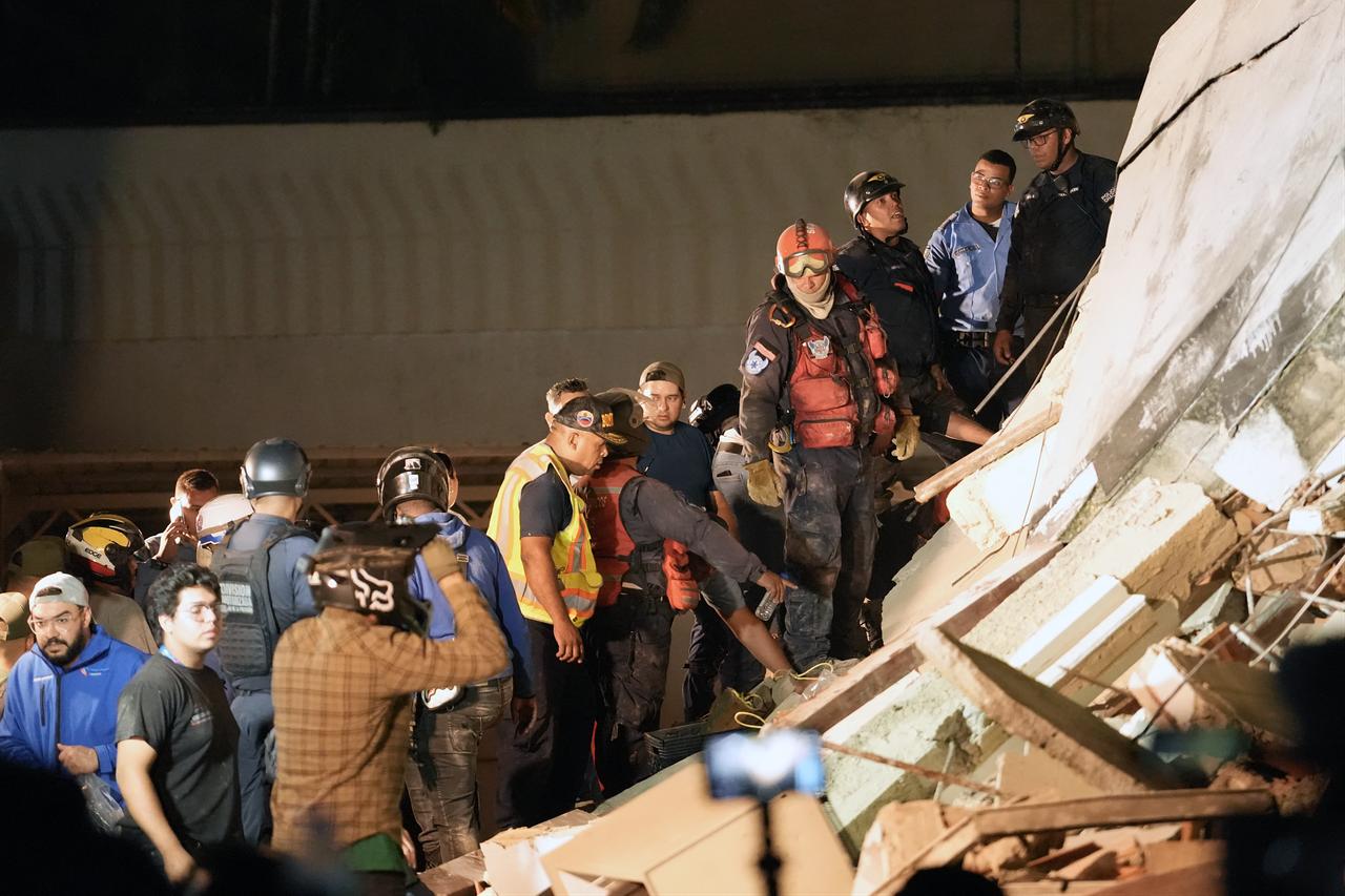 Rescuers work on the remains of a collapsed building following an earthquake in Caracas on June 24, 2026. (AFP Photo)