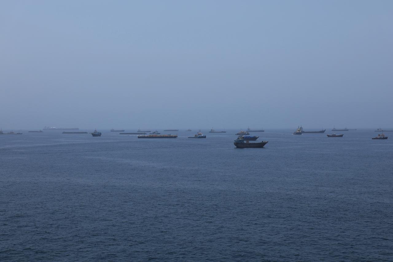 A view of commercial cargo vessels and crude oil tankers are anchored in the Gulf of Oman, off the coast of Muscat, Oman, June 21, 2026. (AA Photo)