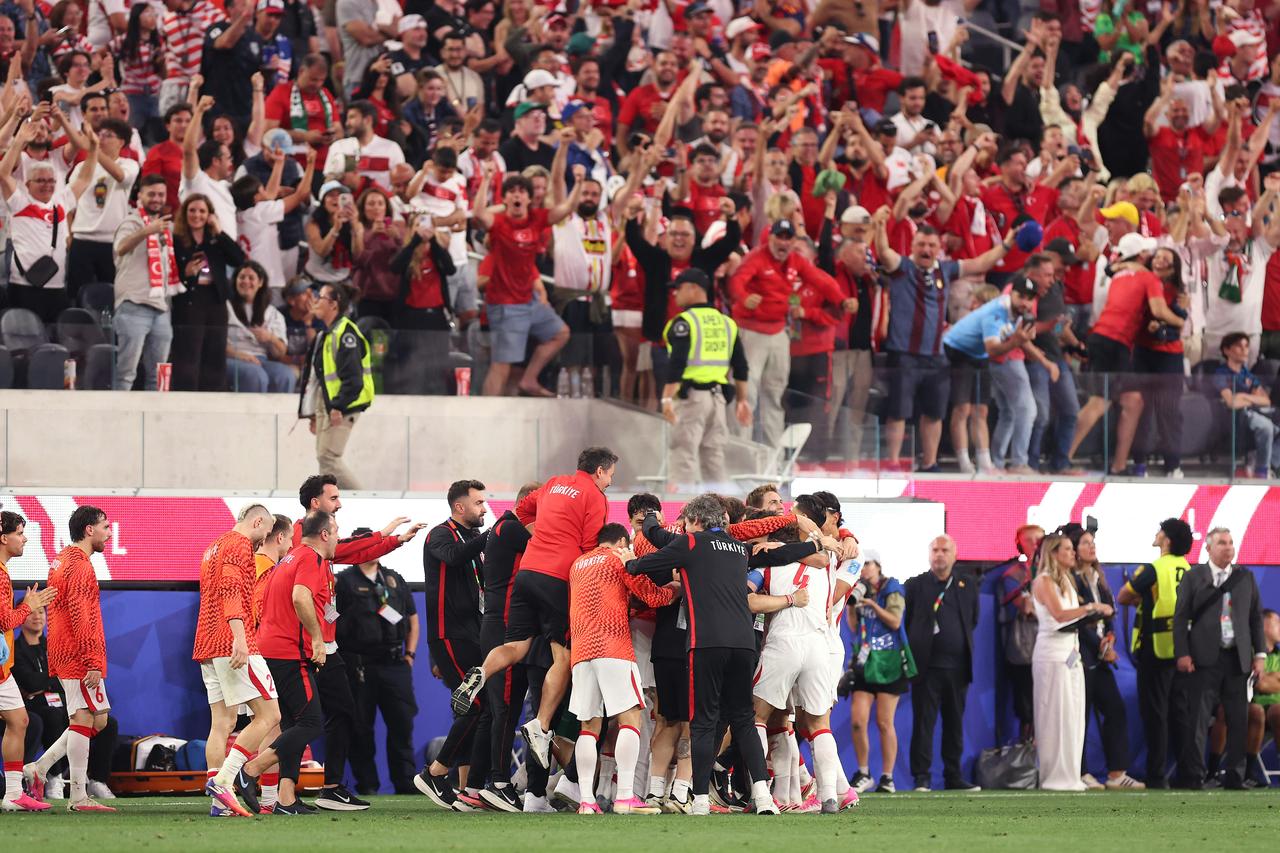 Kaan Ayhan #22 of Turkiye (obscured) celebrates with teammates scoring his team's third goal during the FIFA World Cup 2026 Group D match between Türkiye and USA at Los Angeles Stadium on June 25, 2026 in Inglewood, California. (AFP Photo)