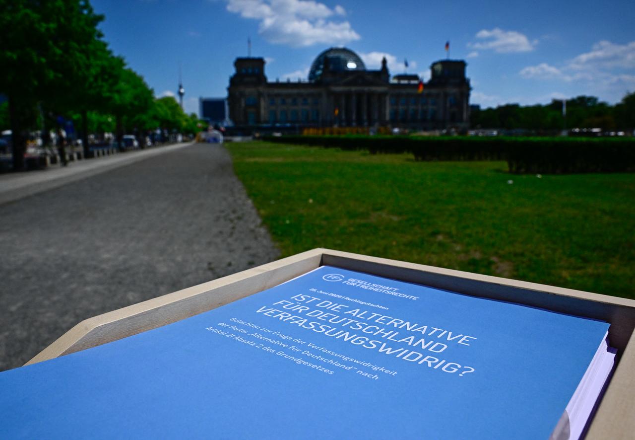 A report realized by the Society for Civil Rights (GFF) on a possible unconstitutionality of the farright AfD party, is displayed on June 25, 2026 in front of the Reichstag building hosting the German parliament, the Bundestag in Berlin. (AFP Photo)