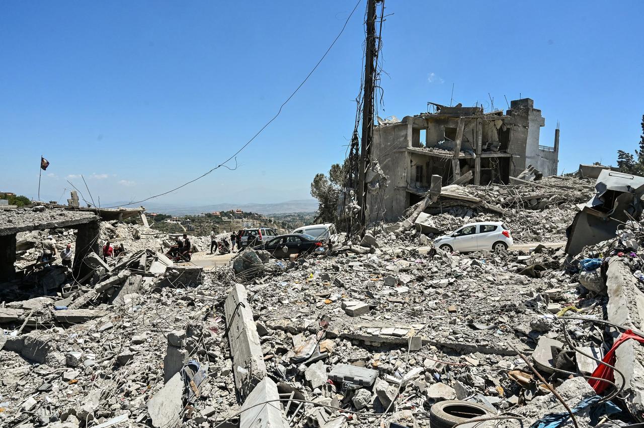 Residents drive past collapsed homes, destroyed in Israeli military strikes, as they return to check on their properties in the southern Lebanese village of Bir Al-Salasil, June 24, 2026. (AFP Photo)