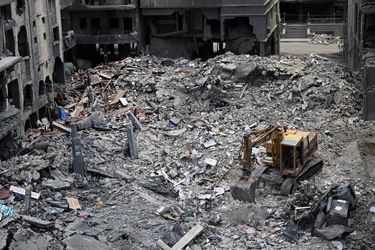 A digger is used as workers remove the rubble of a building from the site of an earlier Israeli military strike on a neighbourhood in the southern Lebanese coastal city of Tyre, June 23, 2026. (AFP Photo)