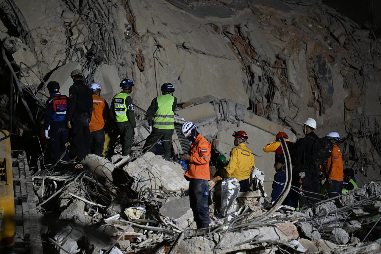 Rescue workers search through the rubble of a collapsed building in Caracas on June 25, 2026, following earthquakes.  June 25, 2026. (AFP Photo)