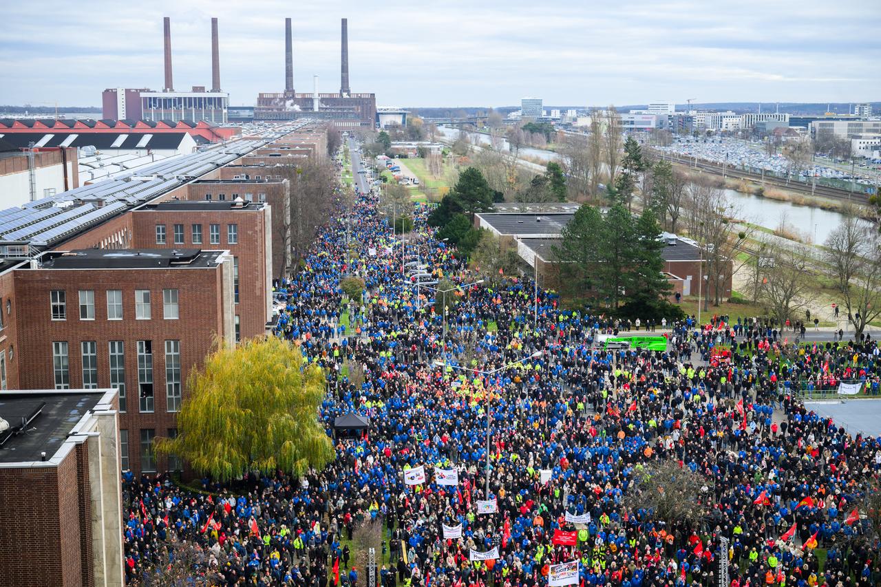 Employees of German car maker Volkswagen (VW) demonstrate outside VW cars plant in Wolfsburg, central Germany, on December 2, 2024, as thousands of Volkswagen workers go on strike all over Germany in an escalating industrial dispute at the crisis-hit German auto giant with thousands of jobs at stake. (AFP File Photo)