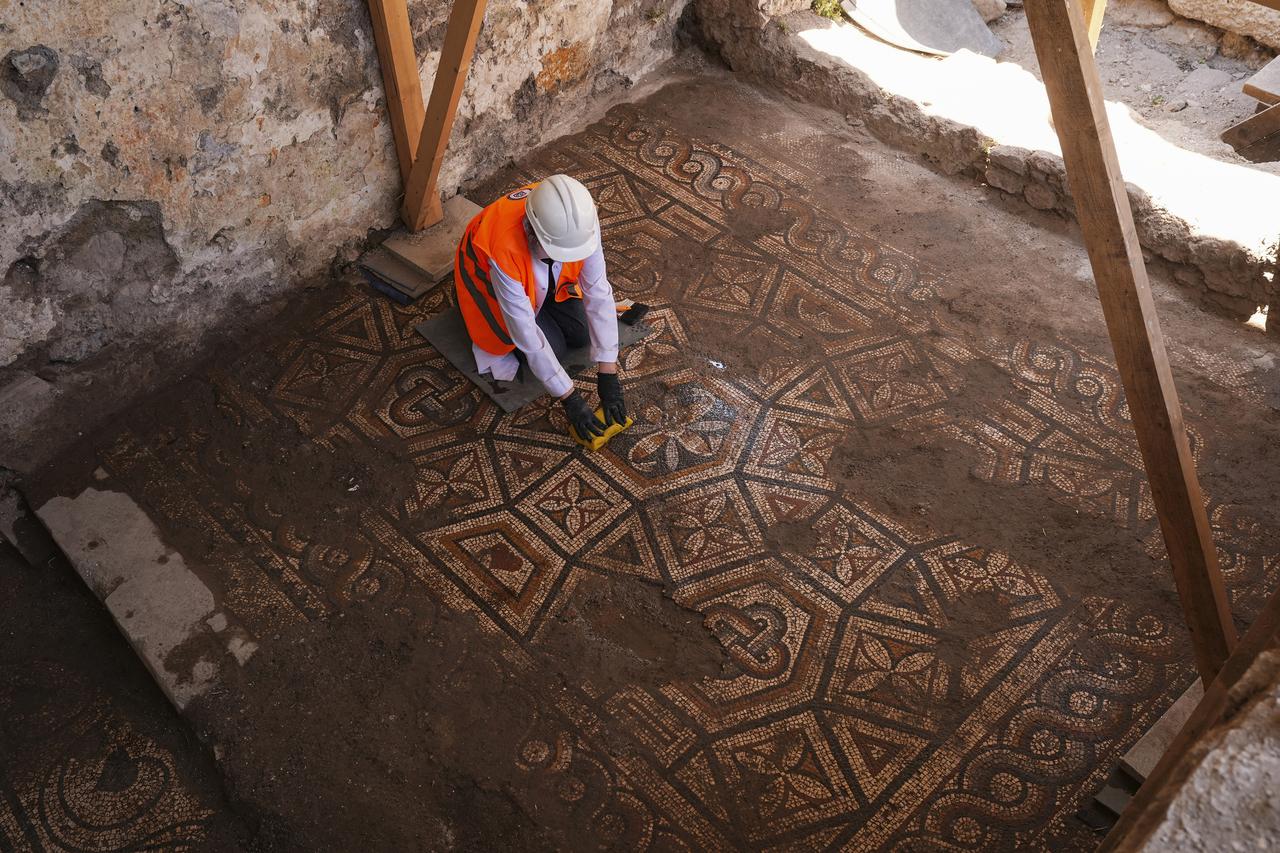 During infrastructure works carried out at the ancient city, a mosaic floor measuring approximately 5 by 2.5 meters was discovered, featuring decorative patterns composed of interlocking 12-sided panels. Izmir, Türkiye, June 27, 2026. (AA Photo)