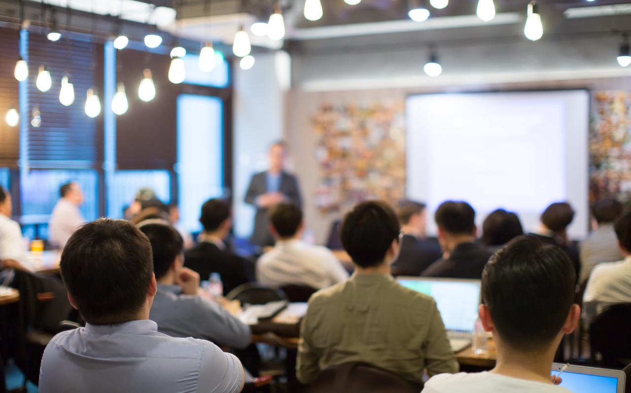 Participants attend a business seminar in a conference room. (Adobe Stock Photo)