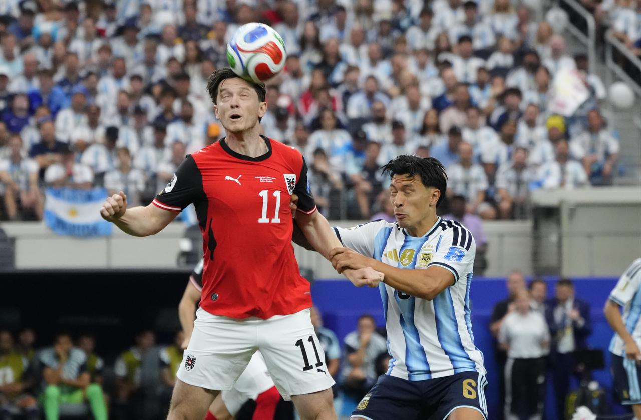 Michael Gregoritsch (11) of Austria and Lisandro Martinez (6) of Argentina compete for the ball during the 2026 FIFA World Cup First Stage Group J match between Argentina and Austria at Dallas Stadium in Arlington, Texas, United States, June 22, 2026. (AA Photo)