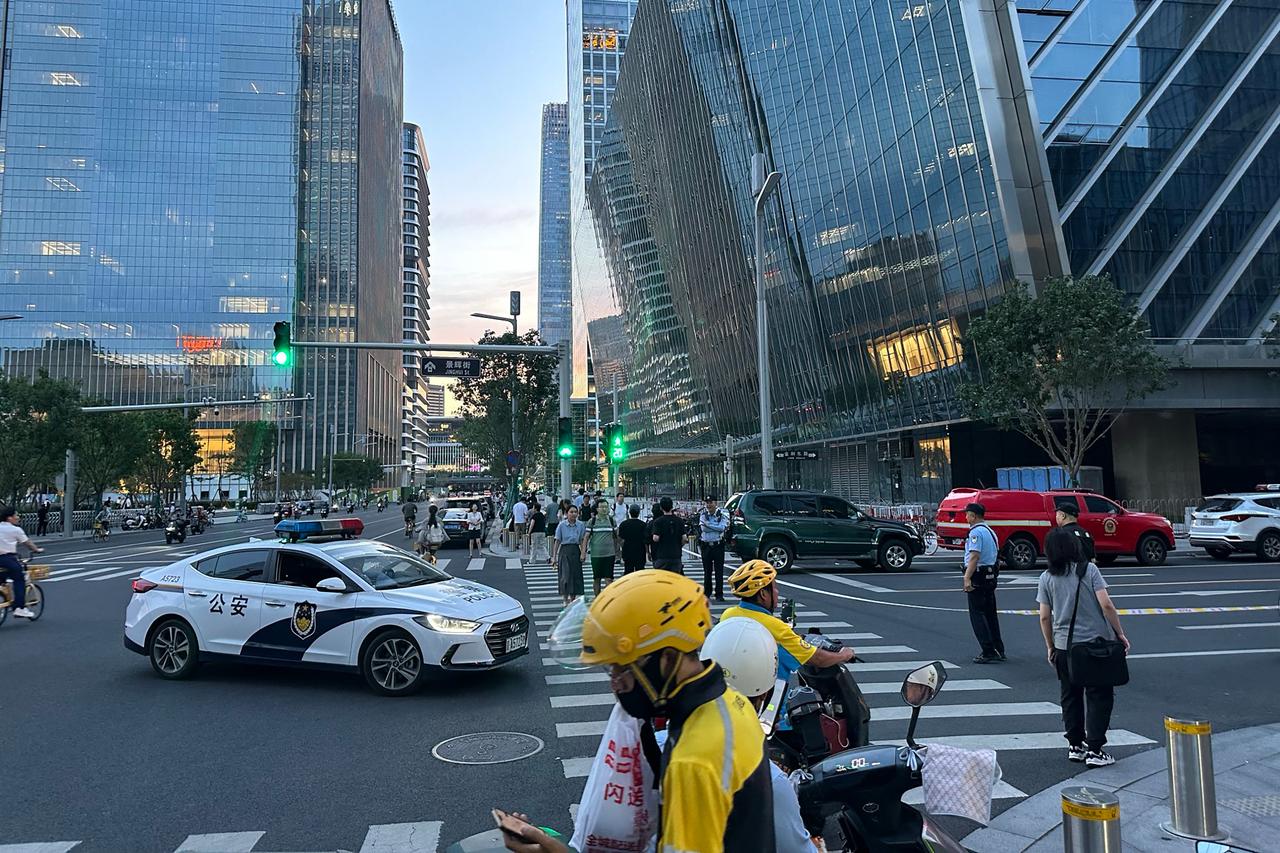 Police keep watch near the CITIC Tower in Beijing on June 26, 2026, after an eyewitness reported plane debris at the base of Beijing's tallest building. (AFP Photo)