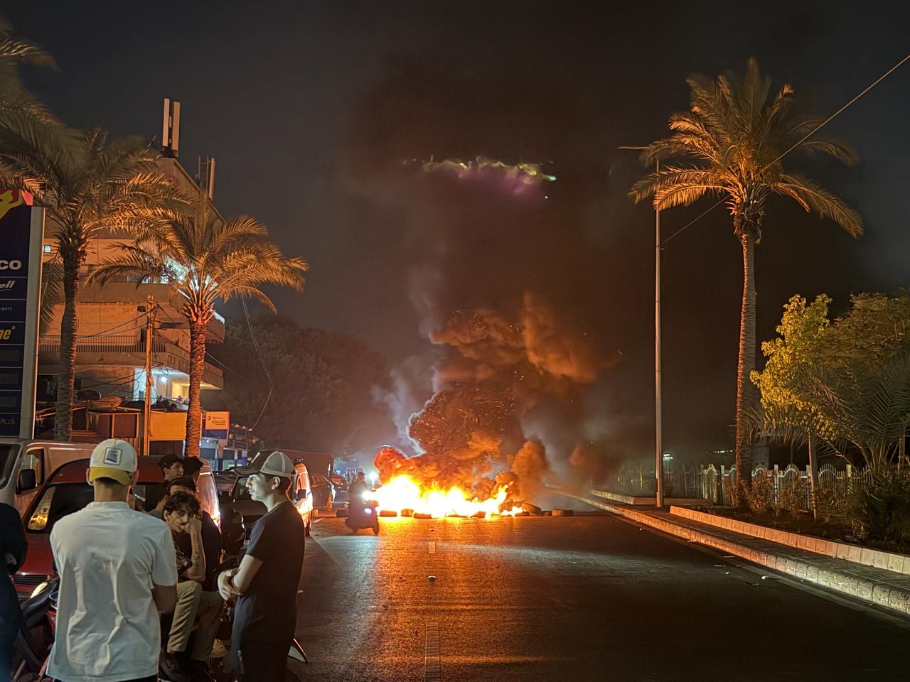 Hezbollah supporters block the old airport road in the southern suburbs of Beirut, with burning tires to protest against the trilateral agreement that was signed between the US, Israel and Lebanon, June 27, 2026. (AFP Photo)
