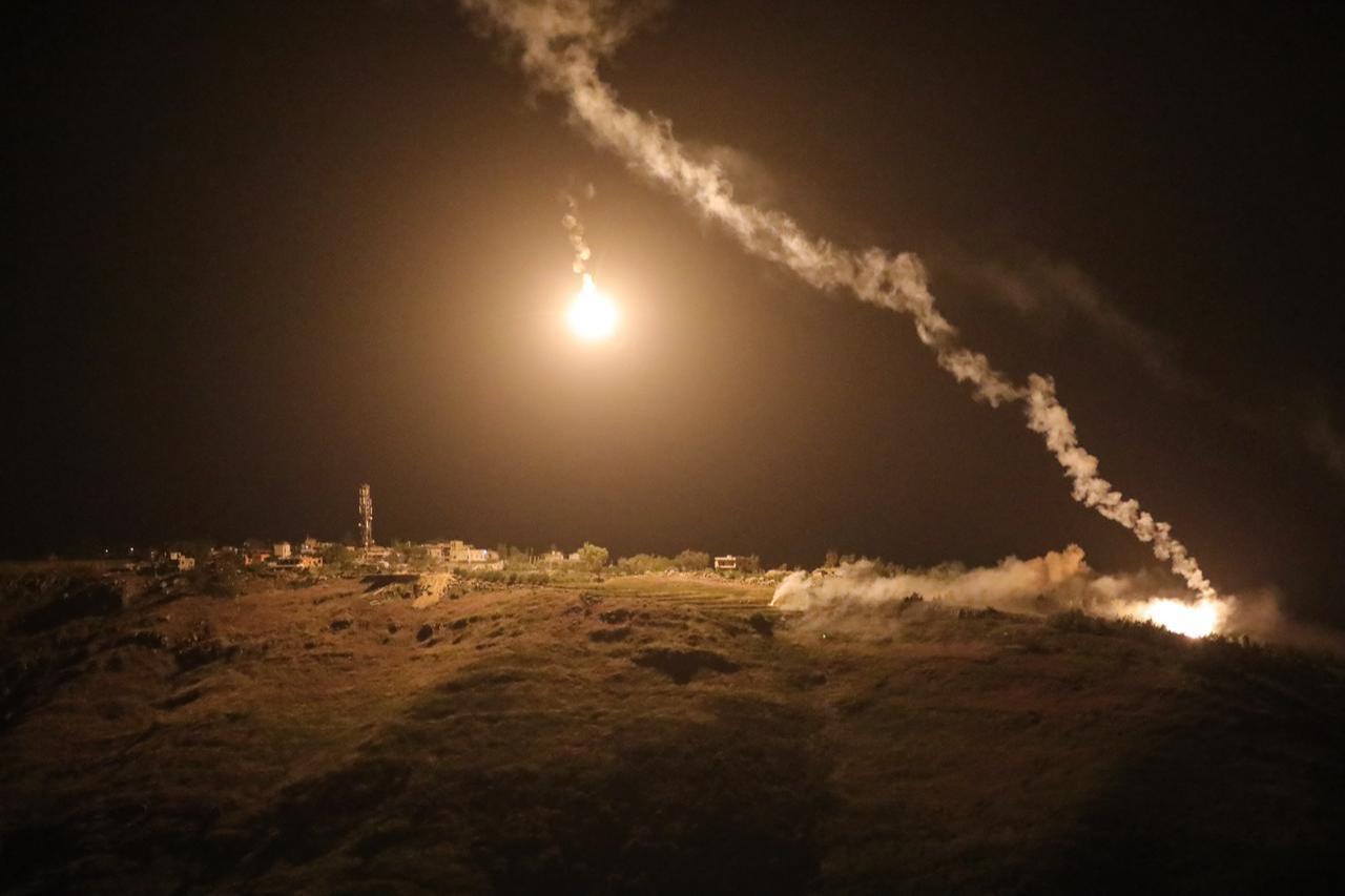 A photograph taken from the southern area of Marjayoun shows flares fired by the Israeli military descending over the village of Arnoun late on May 13, 2026. (AFP Photo)