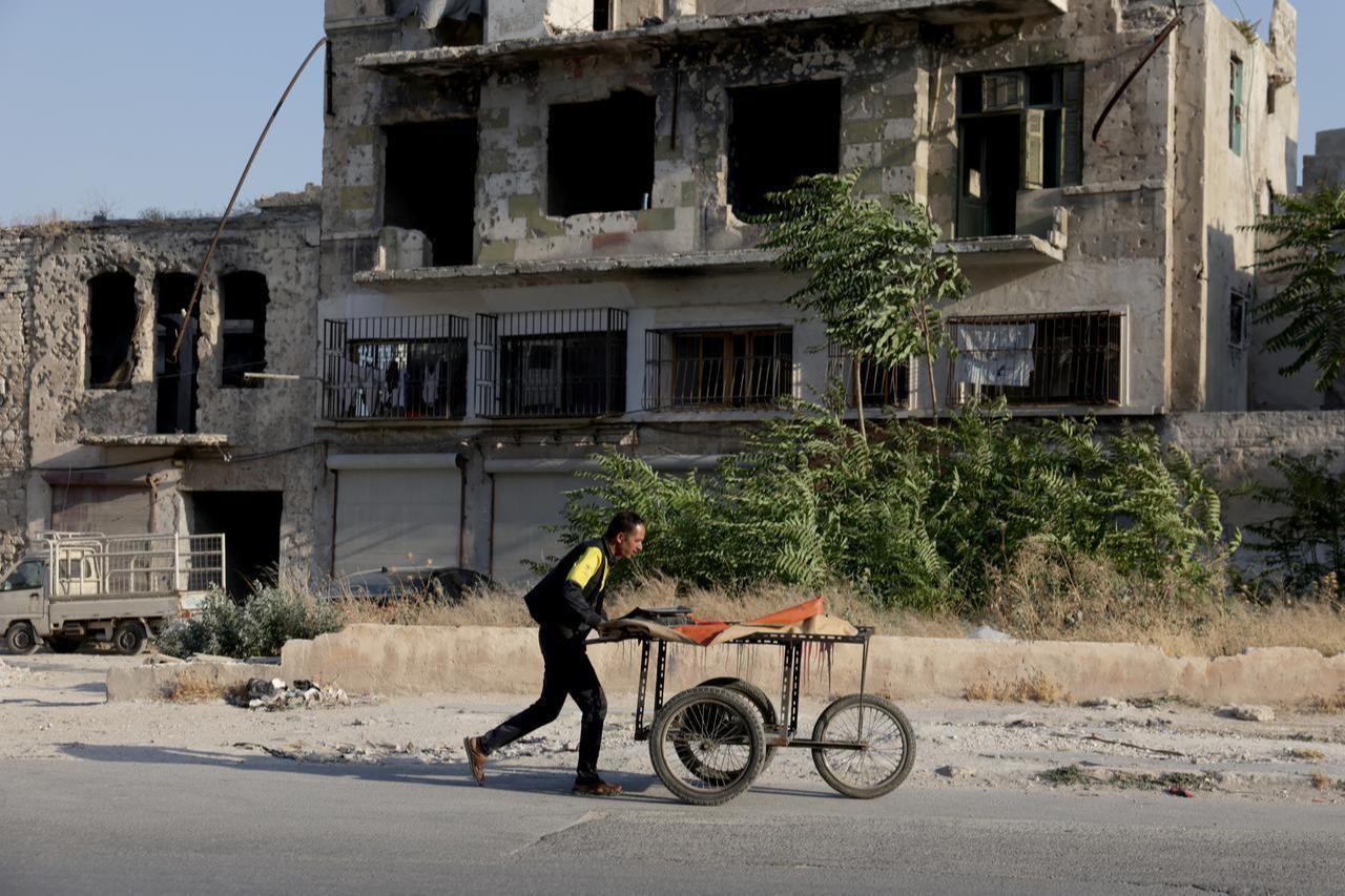 Syrian civilians, who returned to their homes despite the destruction in the neighborhoods around the Citadel of Aleppo, Syria, try to maintain their daily lives, June 24, 2026. (AA Photo)