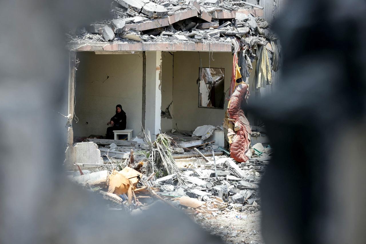 A woman sits in the rubble of her destroyed home in the southern Lebanese village of Toul on June 18, 2026. (AFP Photo)