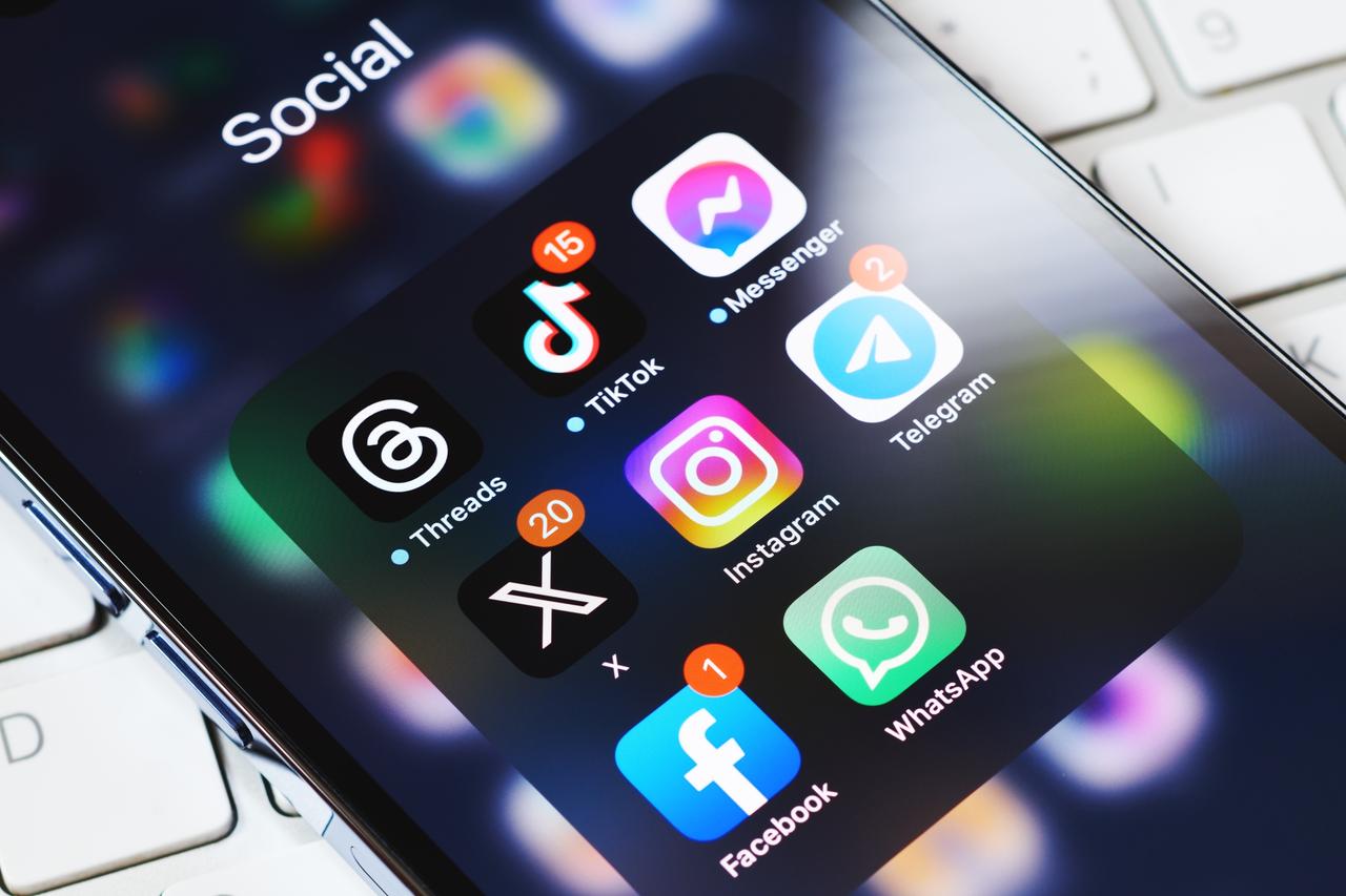 Social media apps are displayed on a smartphone. (Adobe Stock Photo)