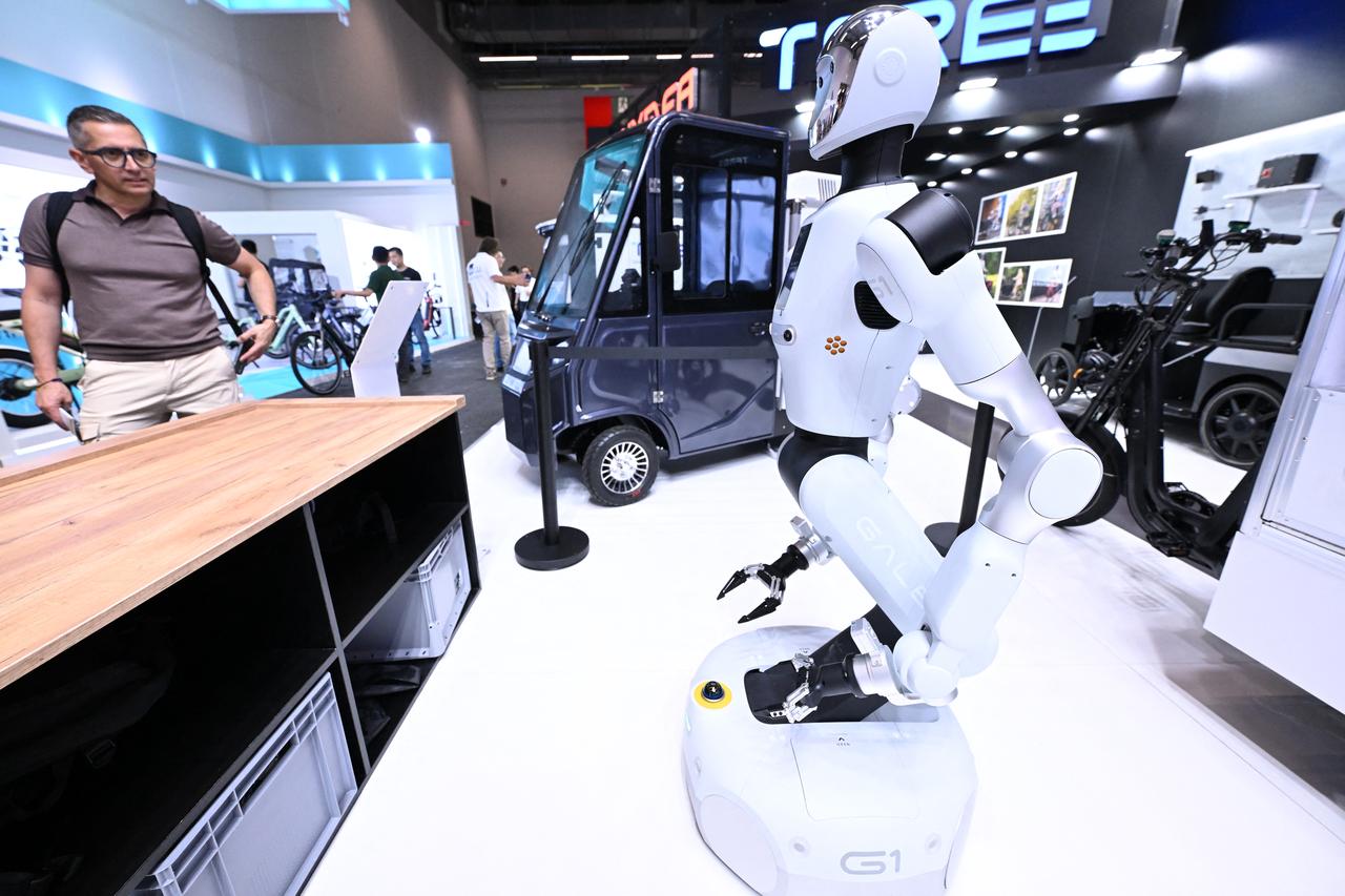 A man looks at a service robot at a booth at the EUROBIKE 2026 fair of the international bicycle industry in Frankfurt am Main, western Germany, June 24, 2026. (AFP Photo)