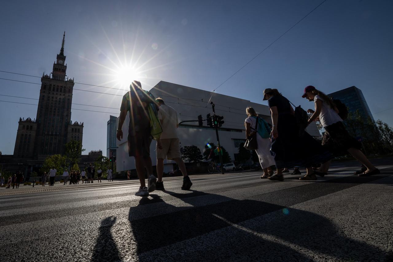 People walk through the street in the centre of Warsaw during the heatwave that has reached Poland, June 27, 2026. (AFP Photo)